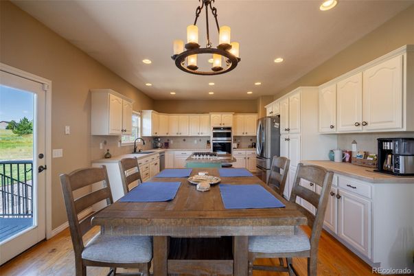 Chandelier, Dining room, Interior, Kitchen, Recessed Lighting, Stainless Steel Appliances, Wood Texture Flooring