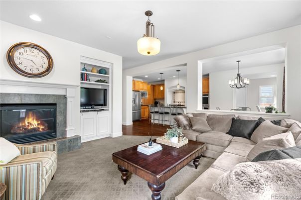Chandelier, Fireplace, Interior, Kitchen, Living room, Pendant Lights, Recessed Lighting, Stainless Steel Appliances, Wood Texture Flooring