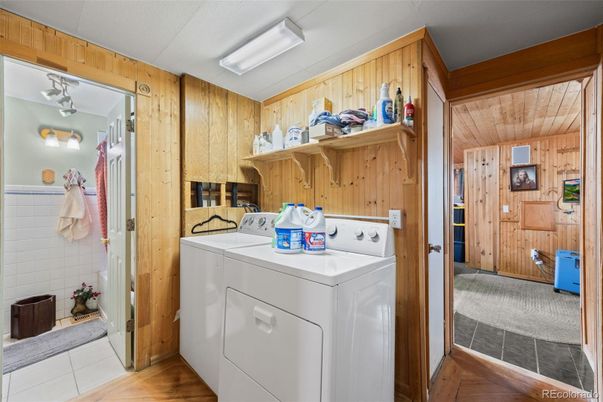 Interior, Utility Closets, Washer, Wood Texture Flooring, Wooden Walls