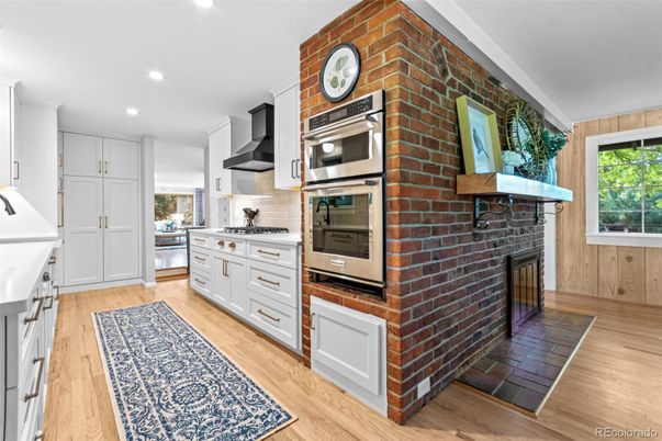 Fireplace, Interior, Kitchen, Recessed Lighting, Stainless Steel Appliances, Stone Walls, Wood Texture Flooring