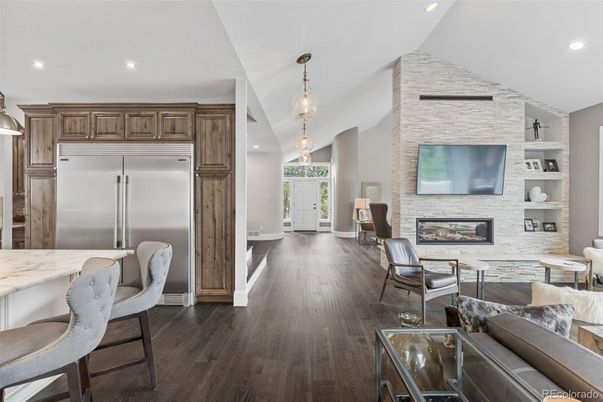 Fireplace, Interior, Kitchen, Living room, Pendant Lights, Recessed Lighting, Stainless Steel Appliances, Stone Walls, Wood Texture Flooring