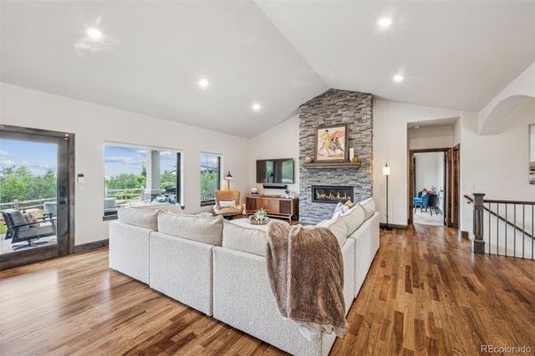 Fireplace, Interior, Living room, Recessed Lighting, Stone Walls, Wood Texture Flooring