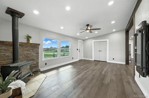 Empty room, Fireplace, Interior, Recessed Lighting, Stone Walls, Wood Texture Flooring