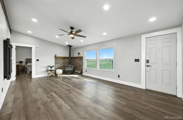 Empty room, Fireplace, Interior, Recessed Lighting, Stone Walls, Wood Texture Flooring