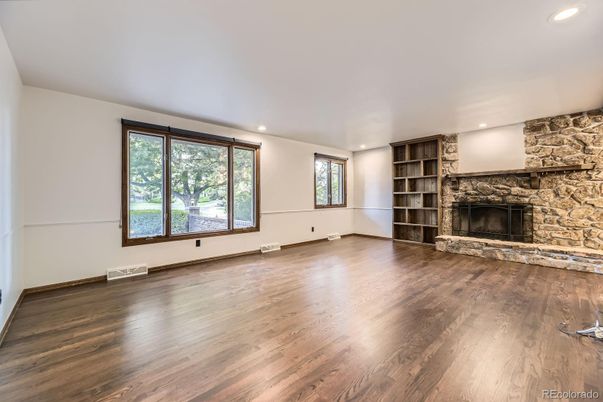Empty room, Fireplace, Interior, Recessed Lighting, Stone Walls, Wood Texture Flooring