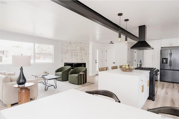 Fireplace, Interior, Kitchen, Living room, Pendant Lights, Recessed Lighting, Stainless Steel Appliances, Stone Walls, Wood Texture Flooring