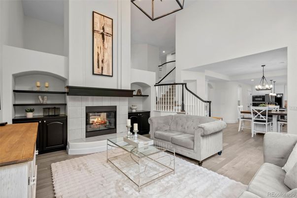 Chandelier, Dining room, Fireplace, Interior, Living room, Pendant Lights, Recessed Lighting, Wood Texture Flooring