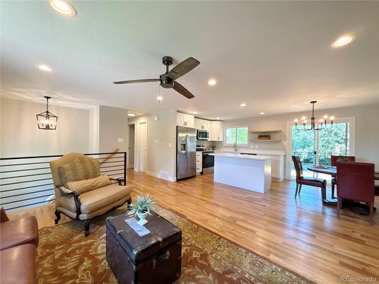 Chandelier, Dining room, Interior, Kitchen, Living room, Pendant Lights, Recessed Lighting, Stainless Steel Appliances, Wood Texture Flooring