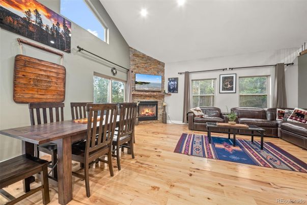 Dining room, Fireplace, Interior, Living room, Recessed Lighting, Stone Walls, Wood Texture Flooring