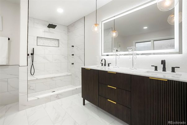 Bathroom, Dual Sink Vanities, Glass Shower, Interior, Marble, Marble Walls, Pendant Lights, Recessed Lighting