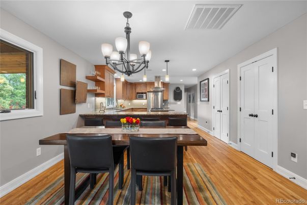 Chandelier, Dining room, Interior, Kitchen, Recessed Lighting, Stainless Steel Appliances, Wood Texture Flooring