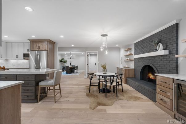 Dining room, Fireplace, Interior, Kitchen, Pendant Lights, Recessed Lighting, Stainless Steel Appliances, Stone Walls, Wood Texture Flooring