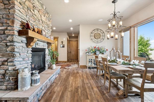 Chandelier, Dining room, Fireplace, Interior, Pendant Lights, Recessed Lighting, Stone Walls, Wood Texture Flooring