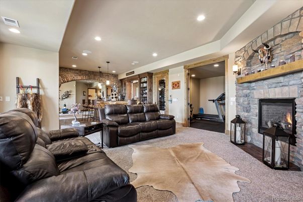 Dining room, Fireplace, Fitness Equipment, Interior, Living room, Pendant Lights, Recessed Lighting, Stone Walls
