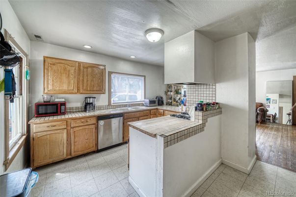 Interior, Kitchen, Recessed Lighting, Tile Countertops, Wood Texture Flooring