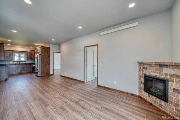 Empty room, Fireplace, Interior, Kitchen, Recessed Lighting, Wood Texture Flooring