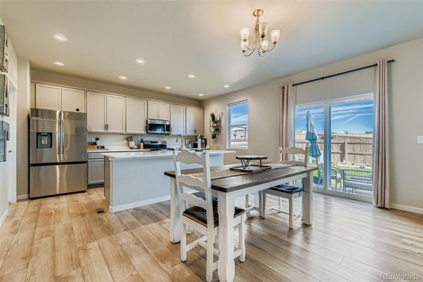 Chandelier, Dining room, Interior, Kitchen, Recessed Lighting, Stainless Steel Appliances, Wood Texture Flooring