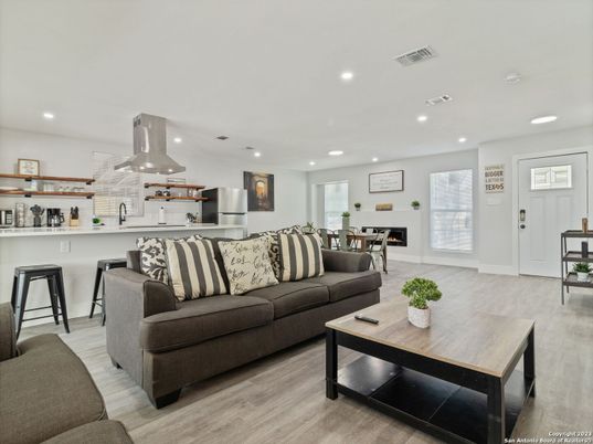Dining room, Fireplace, Interior, Kitchen, Living room, Recessed Lighting, Stainless Steel Appliances, Wood Texture Flooring