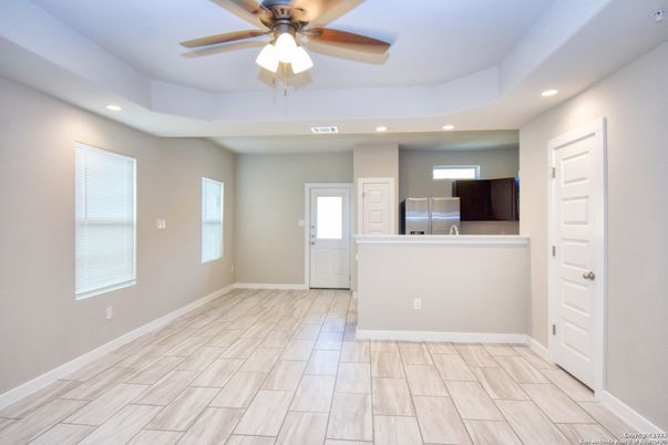 Empty room, Interior, Kitchen, Recessed Lighting, Stainless Steel Appliances, Wood Texture Flooring