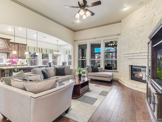 Chandelier, Fireplace, Interior, Living room, Pendant Lights, Recessed Lighting, Stone Walls, Wood Texture Flooring