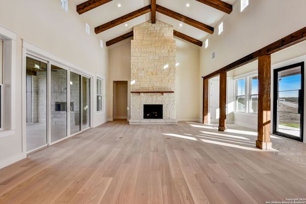 Empty room, Fireplace, Interior, Recessed Lighting, Stone Walls, Wooden Beams, Wood Texture Flooring