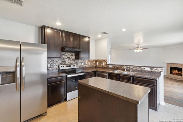 Fireplace, Interior, Kitchen, Recessed Lighting, Stainless Steel Appliances, Wood Texture Flooring