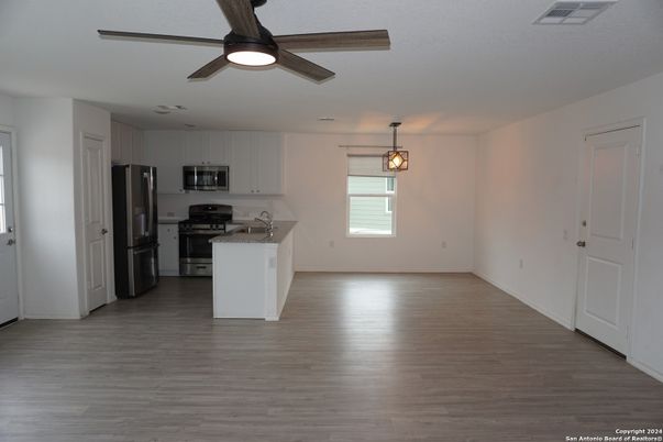 Empty room, Interior, Kitchen, Pendant Lights, Stainless Steel Appliances, Wood Texture Flooring
