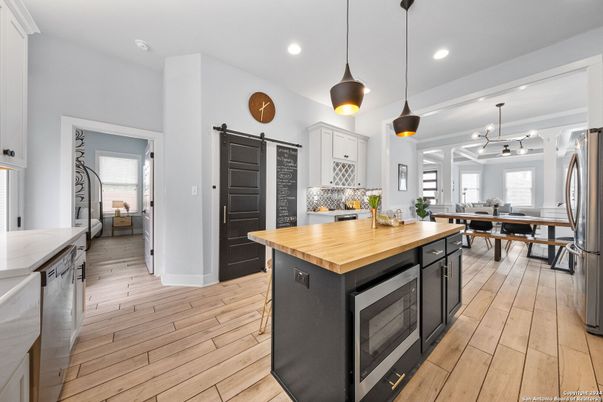 Dining room, Interior, Kitchen, Pendant Lights, Recessed Lighting, Stainless Steel Appliances, Wood Texture Flooring