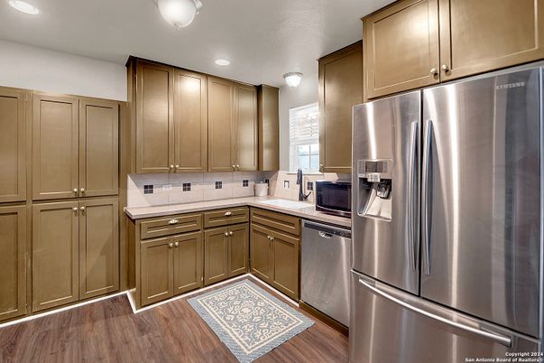 Interior, Kitchen, Recessed Lighting, Stainless Steel Appliances, Tile Countertops, Wood Texture Flooring