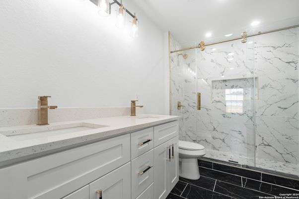 Bathroom, Dual Sink Vanities, Glass Shower, Interior, Marble, Marble Walls, Recessed Lighting