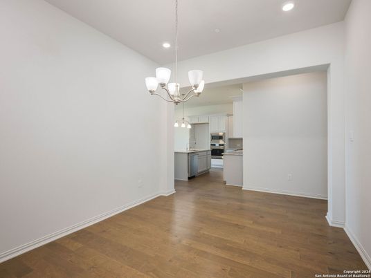 Chandelier, Empty room, Interior, Kitchen, Recessed Lighting, Stainless Steel Appliances, Wood Texture Flooring