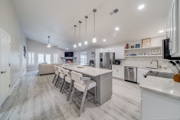 Fireplace, Interior, Kitchen, Living room, Pendant Lights, Recessed Lighting, Stainless Steel Appliances, Wood Texture Flooring