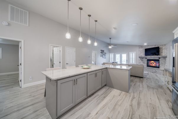 Fireplace, Interior, Kitchen, Living room, Pendant Lights, Recessed Lighting, Stone Walls, Wood Texture Flooring