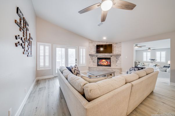 Dining room, Fireplace, Interior, Living room, Recessed Lighting, Stone Walls, Wood Texture Flooring