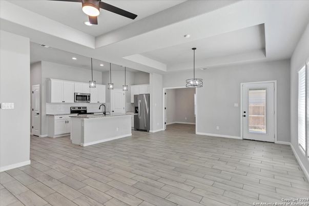 Empty room, Interior, Kitchen, Pendant Lights, Recessed Lighting, Stainless Steel Appliances, Wood Texture Flooring