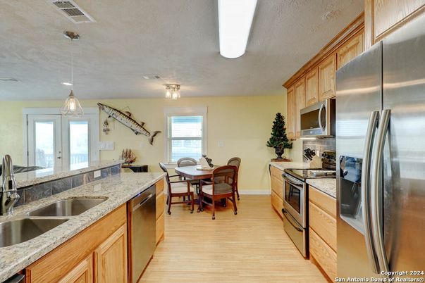 Dining room, Interior, Kitchen, Pendant Lights, Stainless Steel Appliances, Wood Texture Flooring