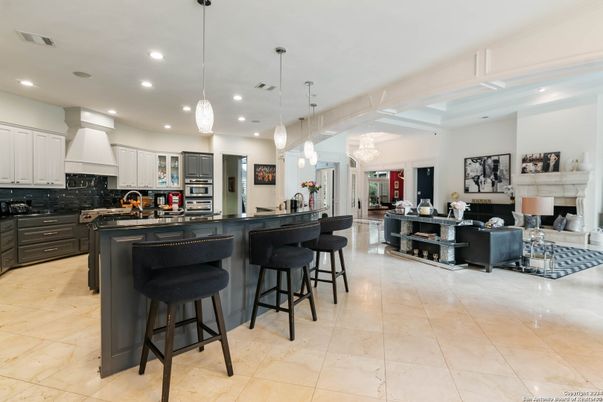 Chandelier, Fireplace, Interior, Kitchen, Living room, Pendant Lights, Recessed Lighting, Stainless Steel Appliances