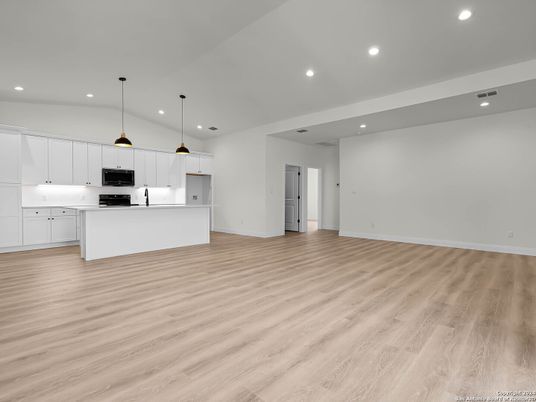 Empty room, Interior, Kitchen, Pendant Lights, Recessed Lighting, Stainless Steel Appliances, Wood Texture Flooring