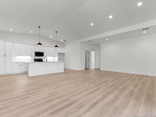 Empty room, Interior, Kitchen, Pendant Lights, Recessed Lighting, Stainless Steel Appliances, Wood Texture Flooring