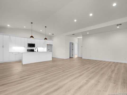 Empty room, Interior, Kitchen, Pendant Lights, Recessed Lighting, Stainless Steel Appliances, Wood Texture Flooring