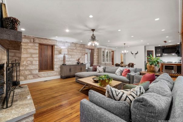 Chandelier, Dining room, Fireplace, Interior, Kitchen, Living room, Pendant Lights, Recessed Lighting, Stone Walls, Wood Texture Flooring