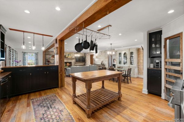 Chandelier, Dining room, Fireplace, Interior, Kitchen, Pendant Lights, Recessed Lighting, Stainless Steel Appliances, Wood Texture Flooring