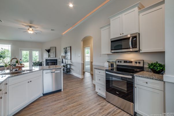 Fireplace, Interior, Kitchen, Recessed Lighting, Stainless Steel Appliances, Wood Texture Flooring