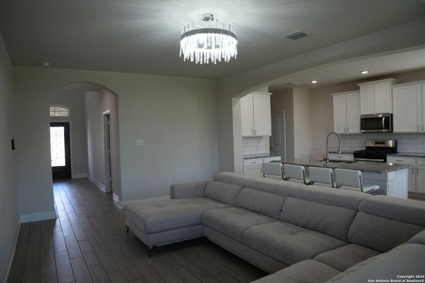 Chandelier, Interior, Kitchen, Living room, Recessed Lighting, Stainless Steel Appliances, Wood Texture Flooring