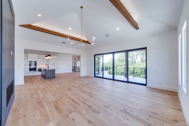 Empty room, Interior, Kitchen, Pendant Lights, Recessed Lighting, Stainless Steel Appliances, Wooden Beams, Wood Texture Flooring