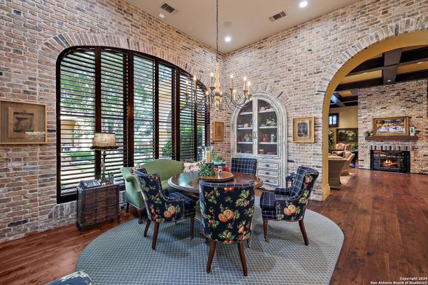 Chandelier, Dining room, Fireplace, Interior, Recessed Lighting, Stone Walls, Wood Texture Flooring