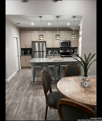 Dining room, Interior, Kitchen, Pendant Lights, Recessed Lighting, Stainless Steel Appliances, Wood Texture Flooring