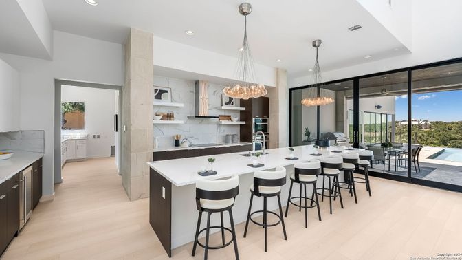 Chandelier, Interior, Kitchen, Marble Walls, Pendant Lights, Recessed Lighting, Stainless Steel Appliances, Wood Texture Flooring