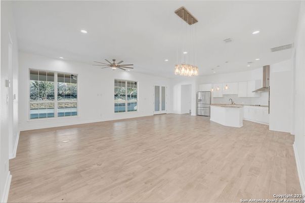 Empty room, Interior, Kitchen, Pendant Lights, Recessed Lighting, Stainless Steel Appliances, Wood Texture Flooring