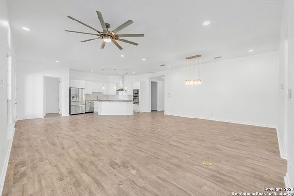Empty room, Interior, Kitchen, Pendant Lights, Recessed Lighting, Stainless Steel Appliances, Wood Texture Flooring
